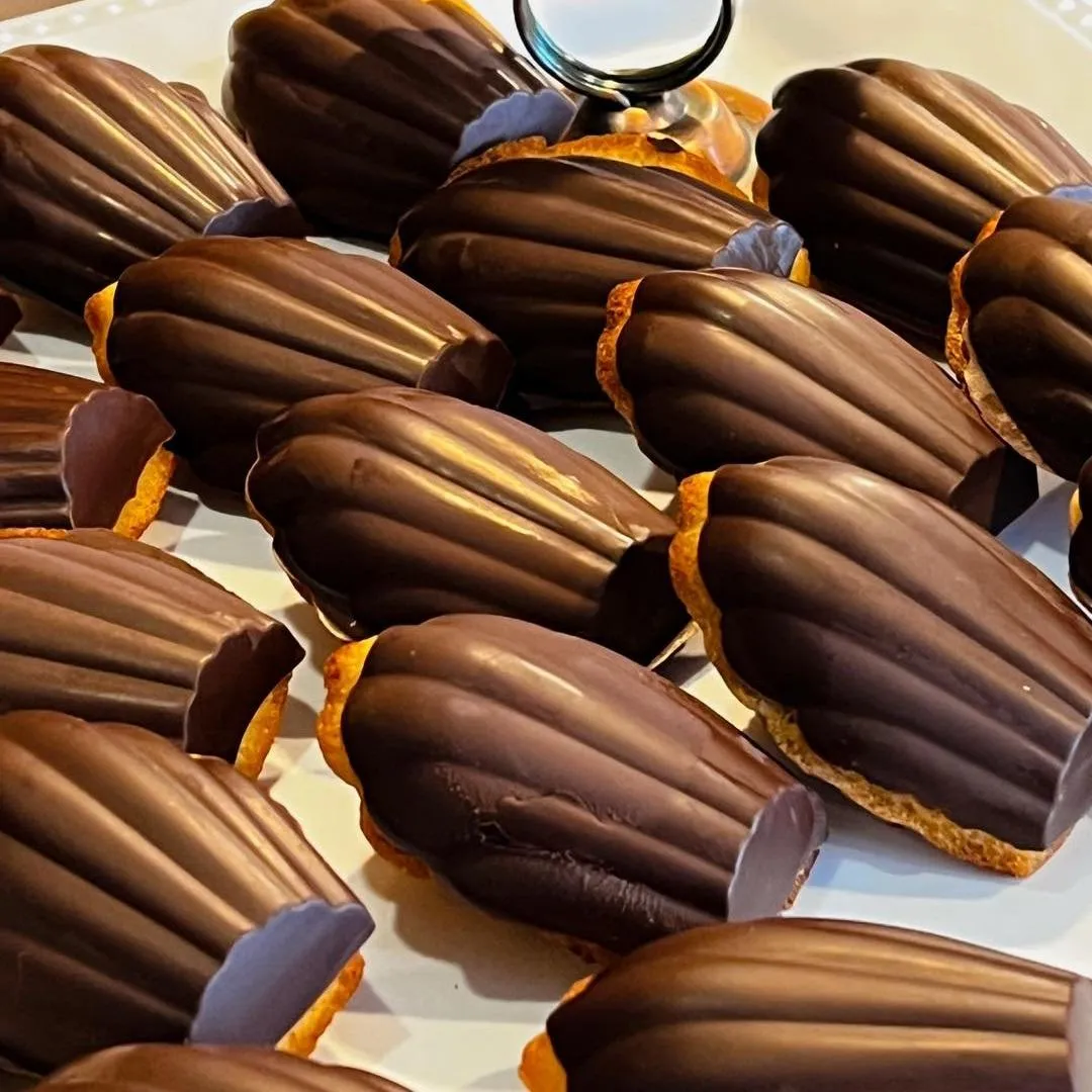 Chocolate-dipped madeleines on a serving tray